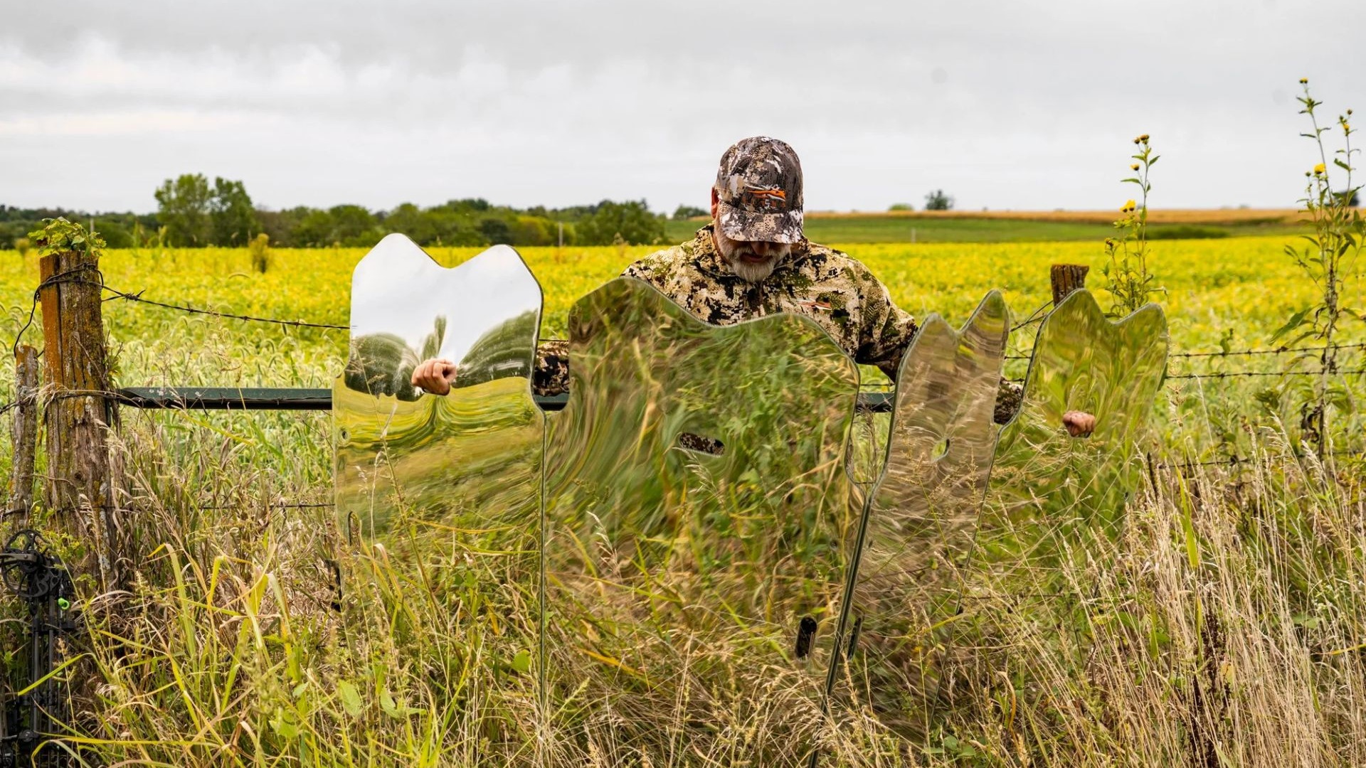 Three GhostBlind mirrored hunting blinds reflecting grass in an open field